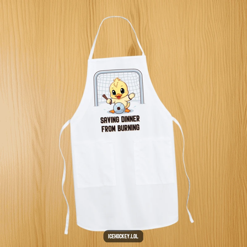 Funny apron showing a determined little duck with wide eyes attempting a goalie save, bringing humorous protection to kitchen duties.