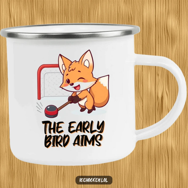 Funny camping mug featuring a determined smiling fox shooting a hockey puck, ideal for outdoor adventures and humor.