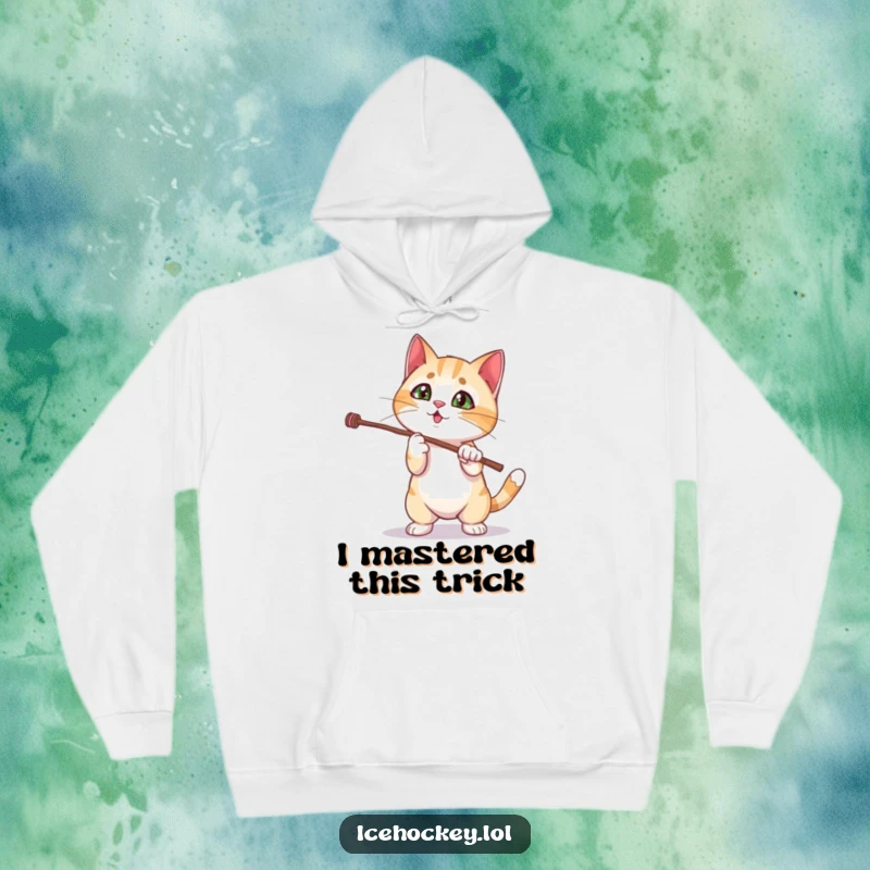 Funny cat hoodie depicting a curious kitten failing to perform a magic stick trick, embodying playful clumsiness and charm.
