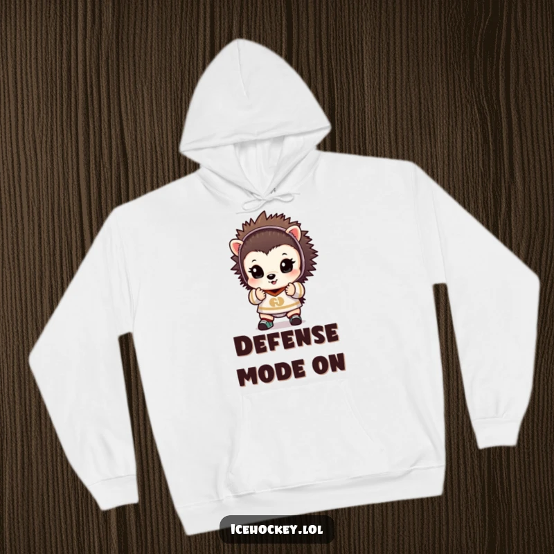 Funny hoodie featuring a tiny hedgehog in full goalie gear, hands raised in a classic save attempt, looking protective.