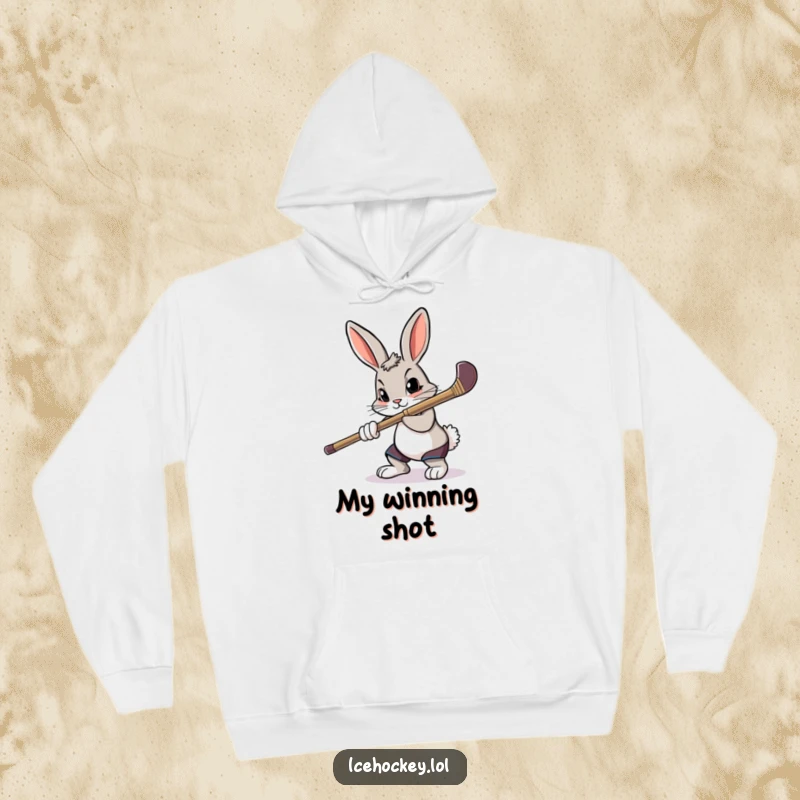 Funny, cozy hoodie featuring a determined rabbit intensely aiming a hockey stick, ready for action.