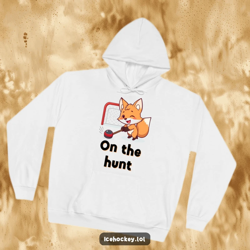 Funny hoodie showing a smiling fox with a determined expression, shooting a hockey puck with great focus and intensity.
