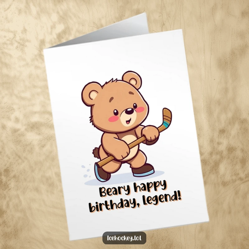 Funny Free Printable Birthday Card: Playful bear cub in hockey gear taking a powerful slap shot, ready to celebrate.