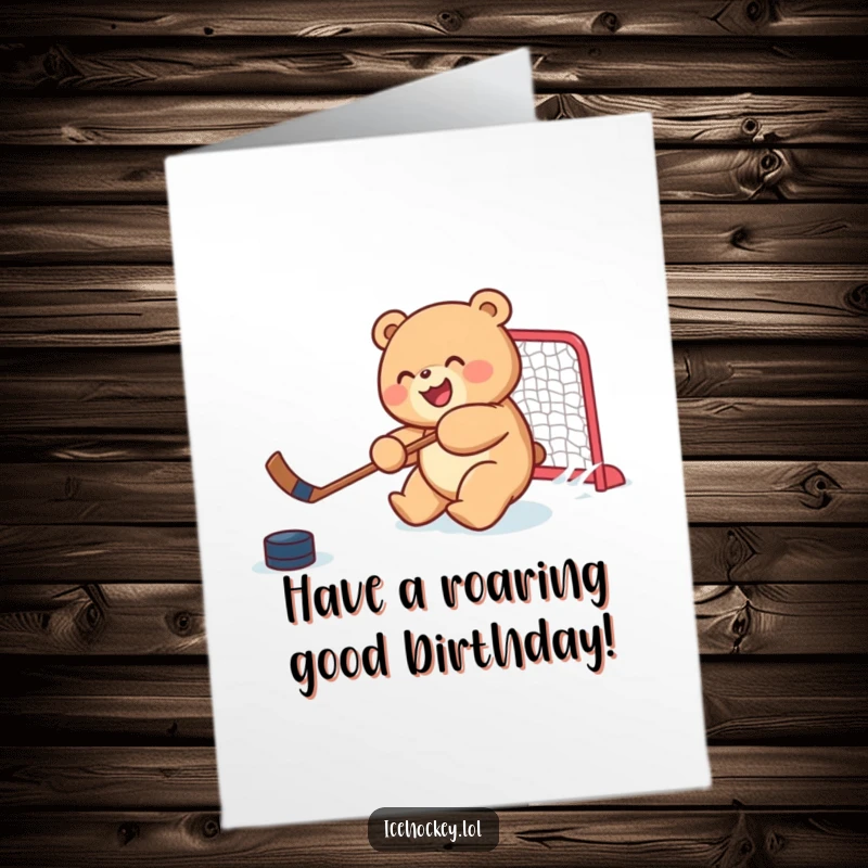 Funny Free Printable Birthday Card: a joyful, round bear cub skillfully shooting a hockey puck towards a net.