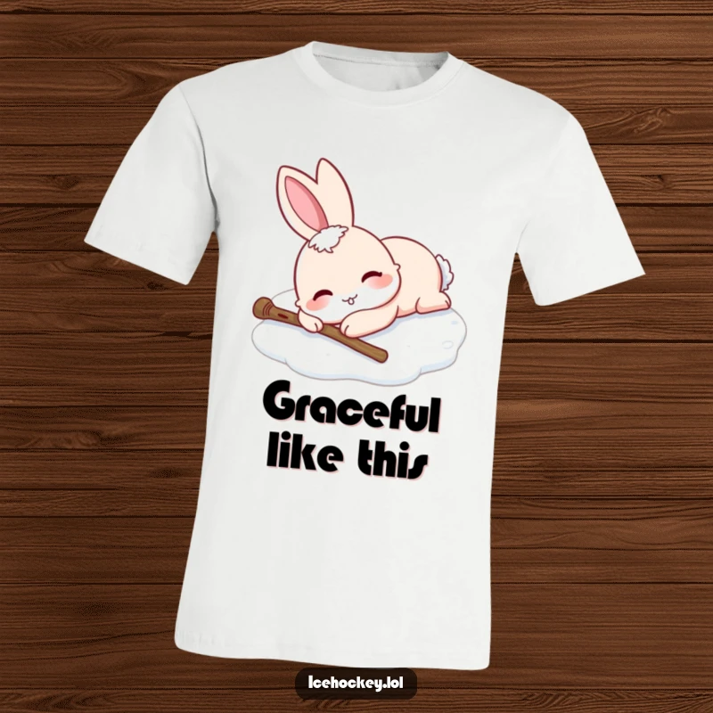 Funny t-shirt showing a smiling rabbit lying on the ice after falling, stick dropped. A humorous item.
