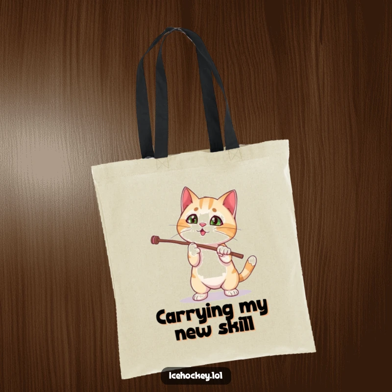 Funny tote bag featuring a curious cat struggling comically with a magic stick trick, showcasing a moment of feline bewilderment.