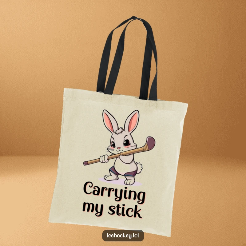 Funny tote bag showcasing a determined rabbit aiming a hockey stick with intense focus.