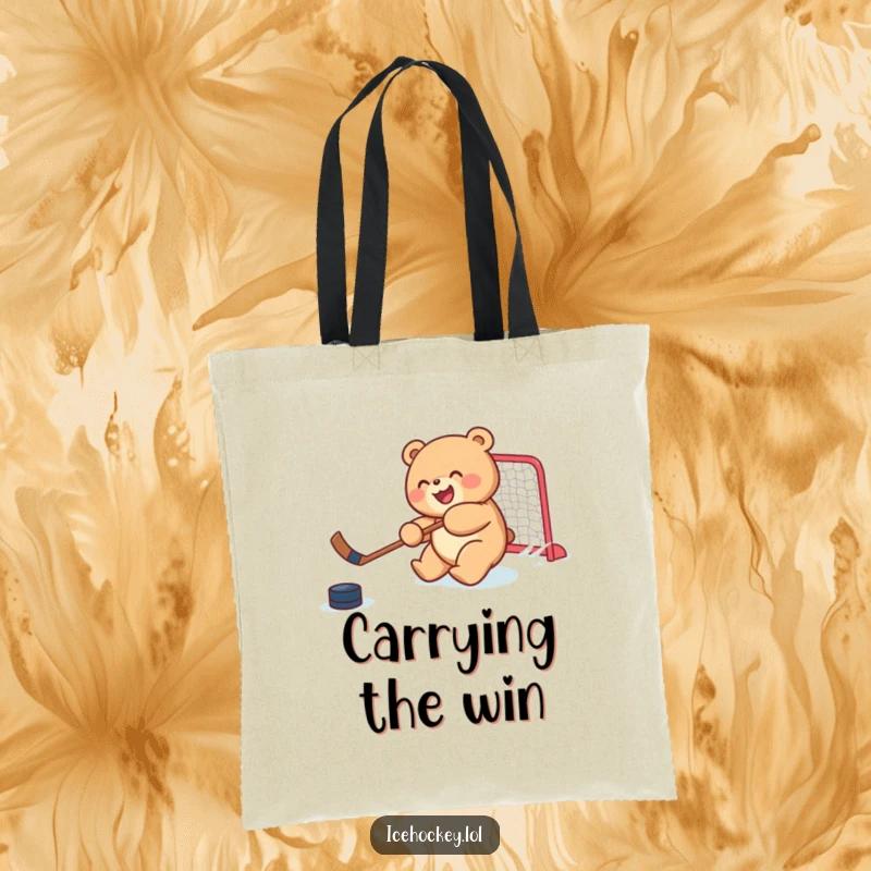 Funny tote bag showcasing a joyful, round bear cub skillfully shooting a hockey puck, a humorous and practical sports accessory.